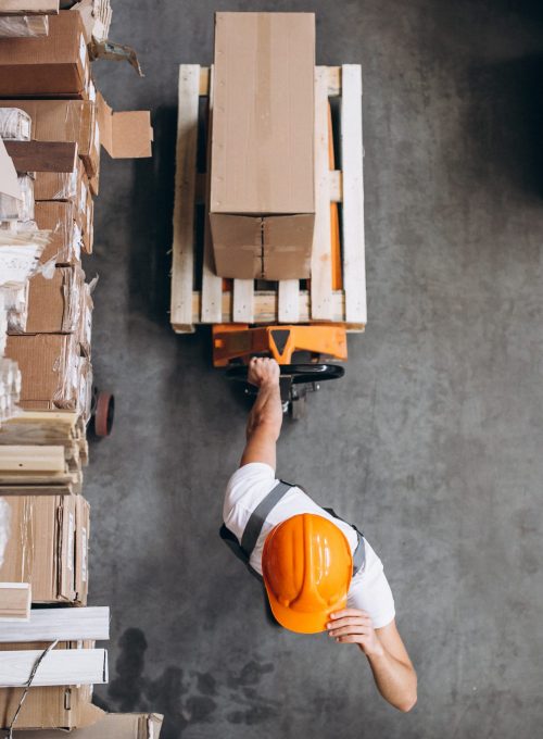 Young man working at a warehouse with boxes
